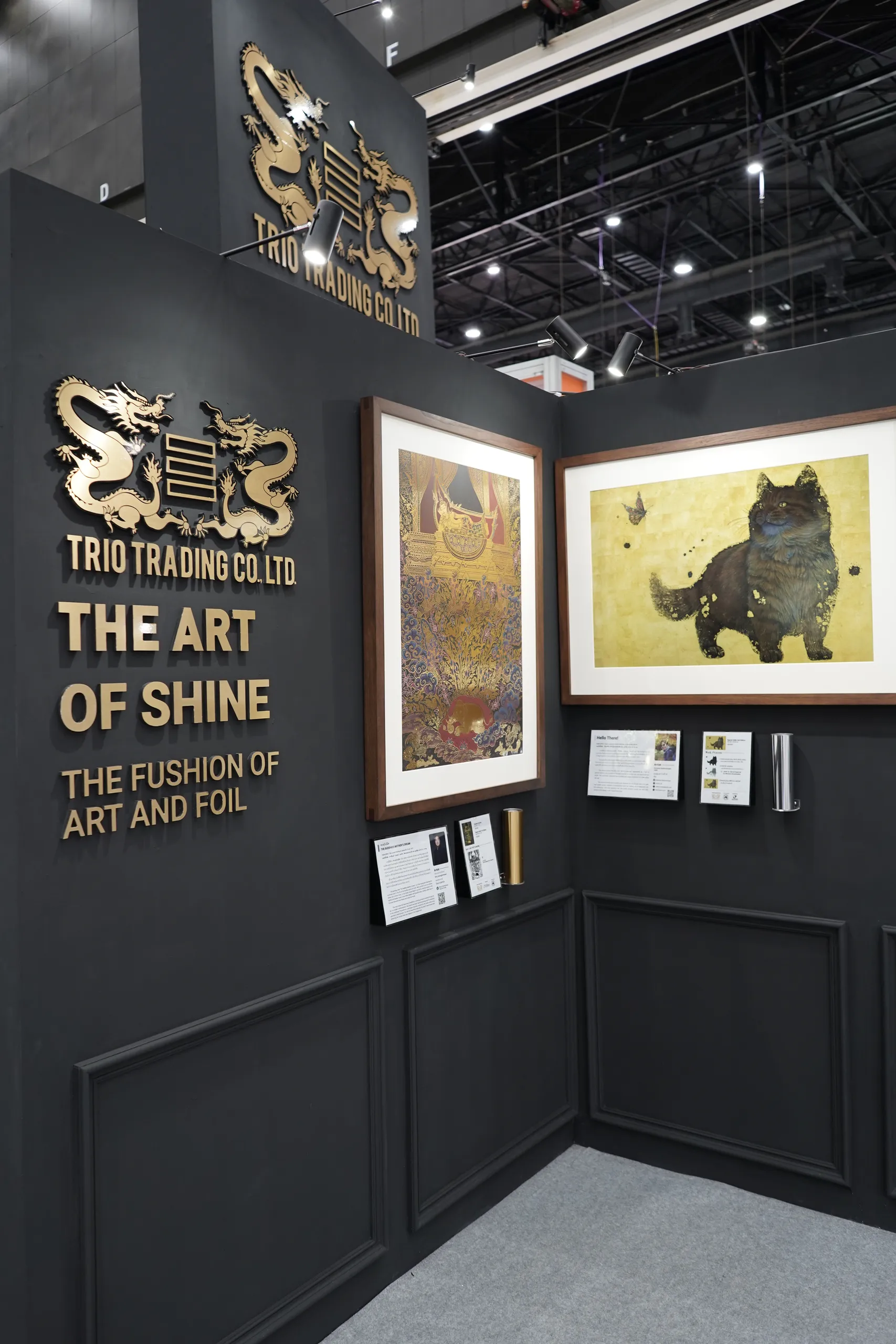 The Art of Shine sign and framed works on the black booth wall