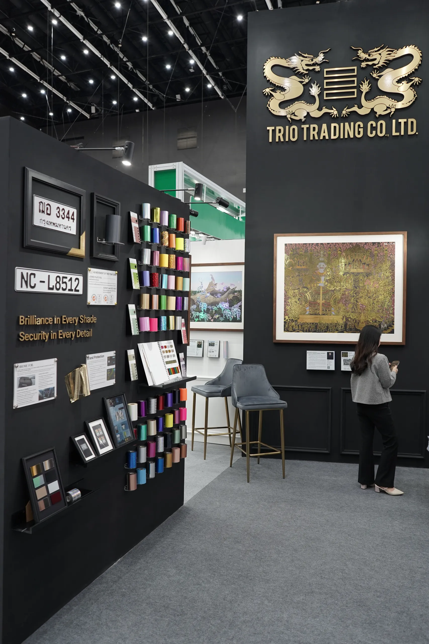 The Trio Trading booth with foil samples and framed works
