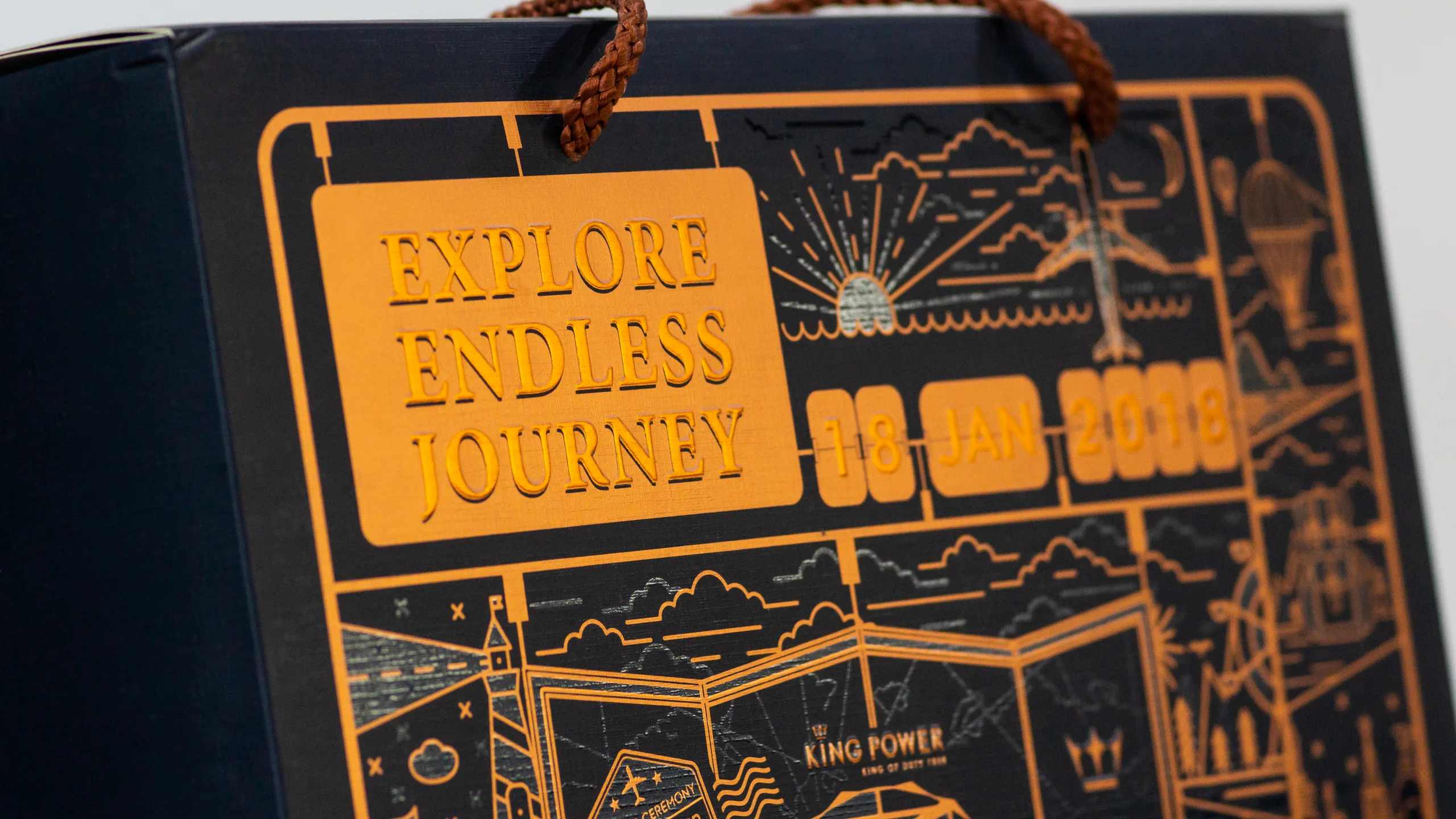 Matte gold foil artwork on a King Power gift box