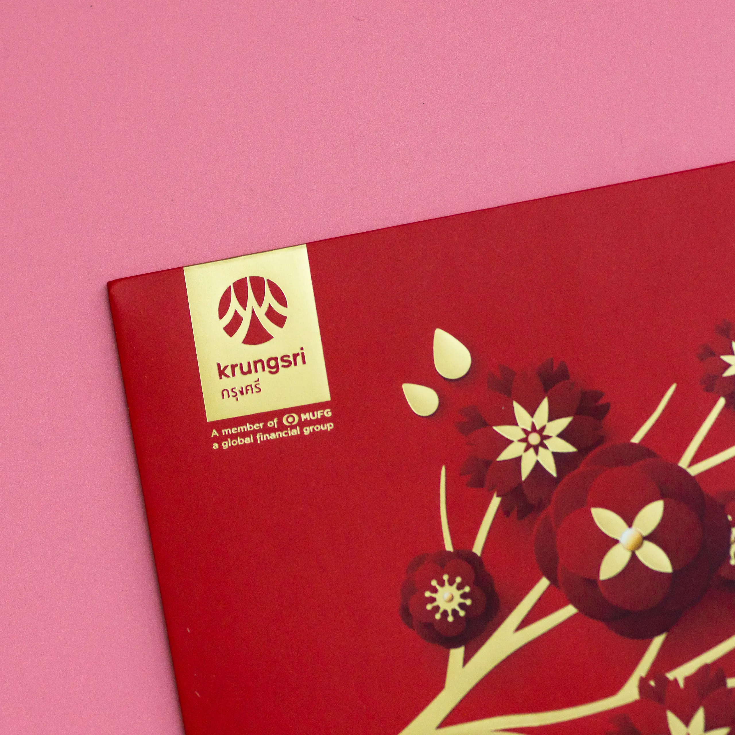 Matte gold foil flowers on a Krungsri envelope