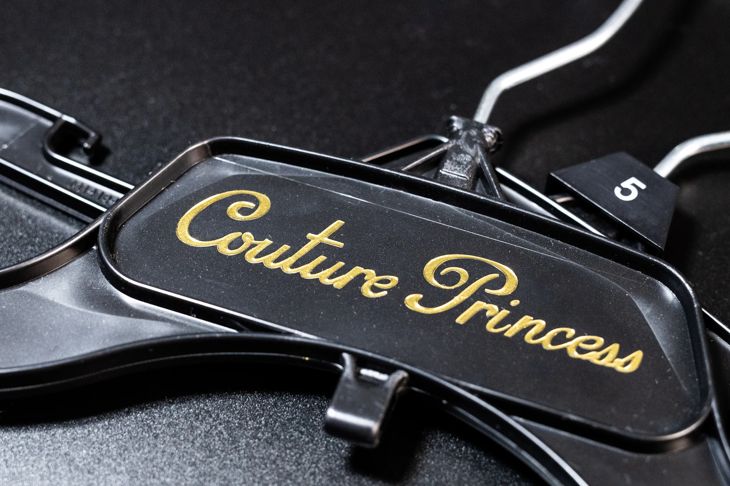 Gold metallic foil logo on a clothes hanger