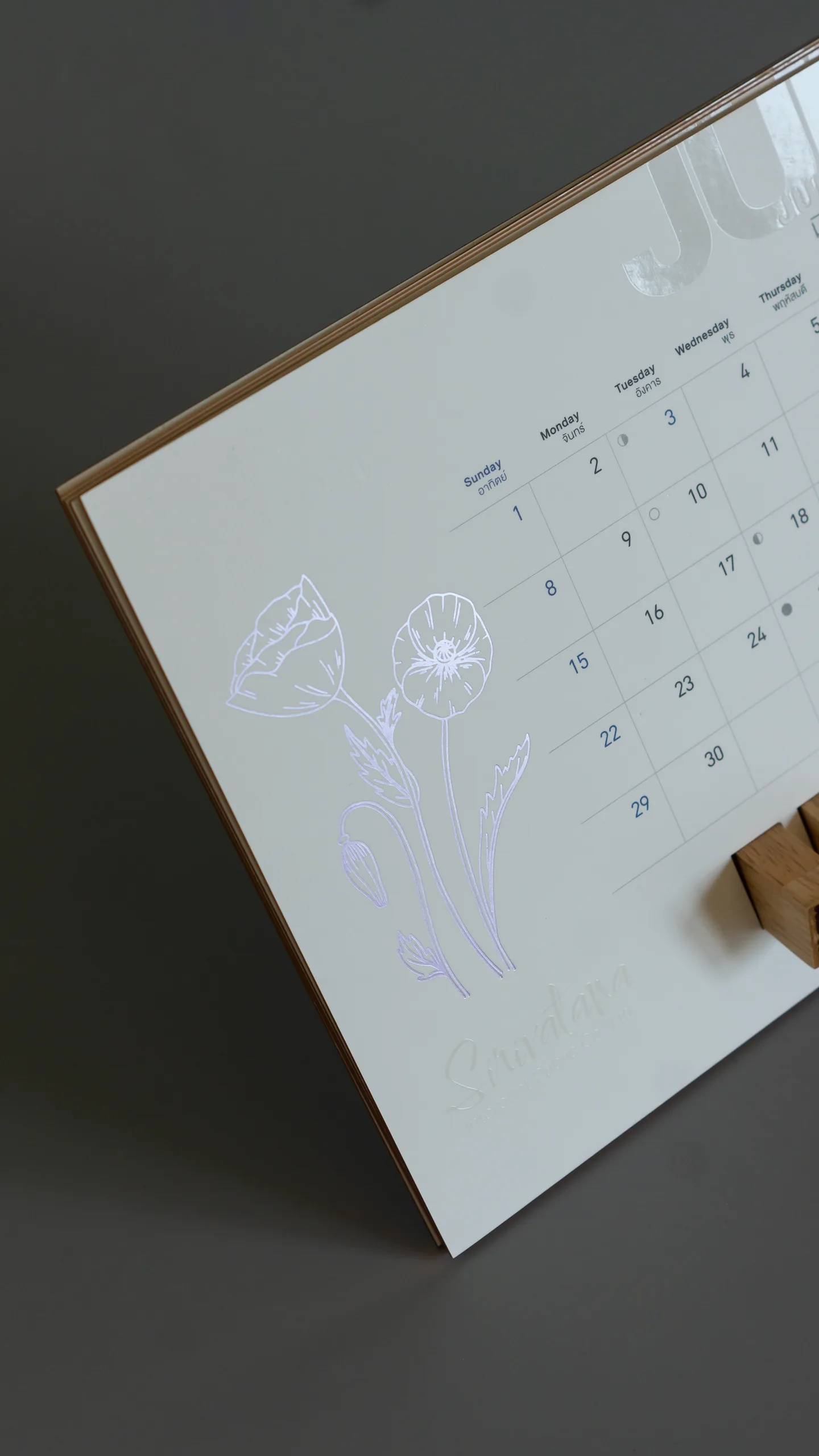 Violet pearl foil tulips on a desk calendar