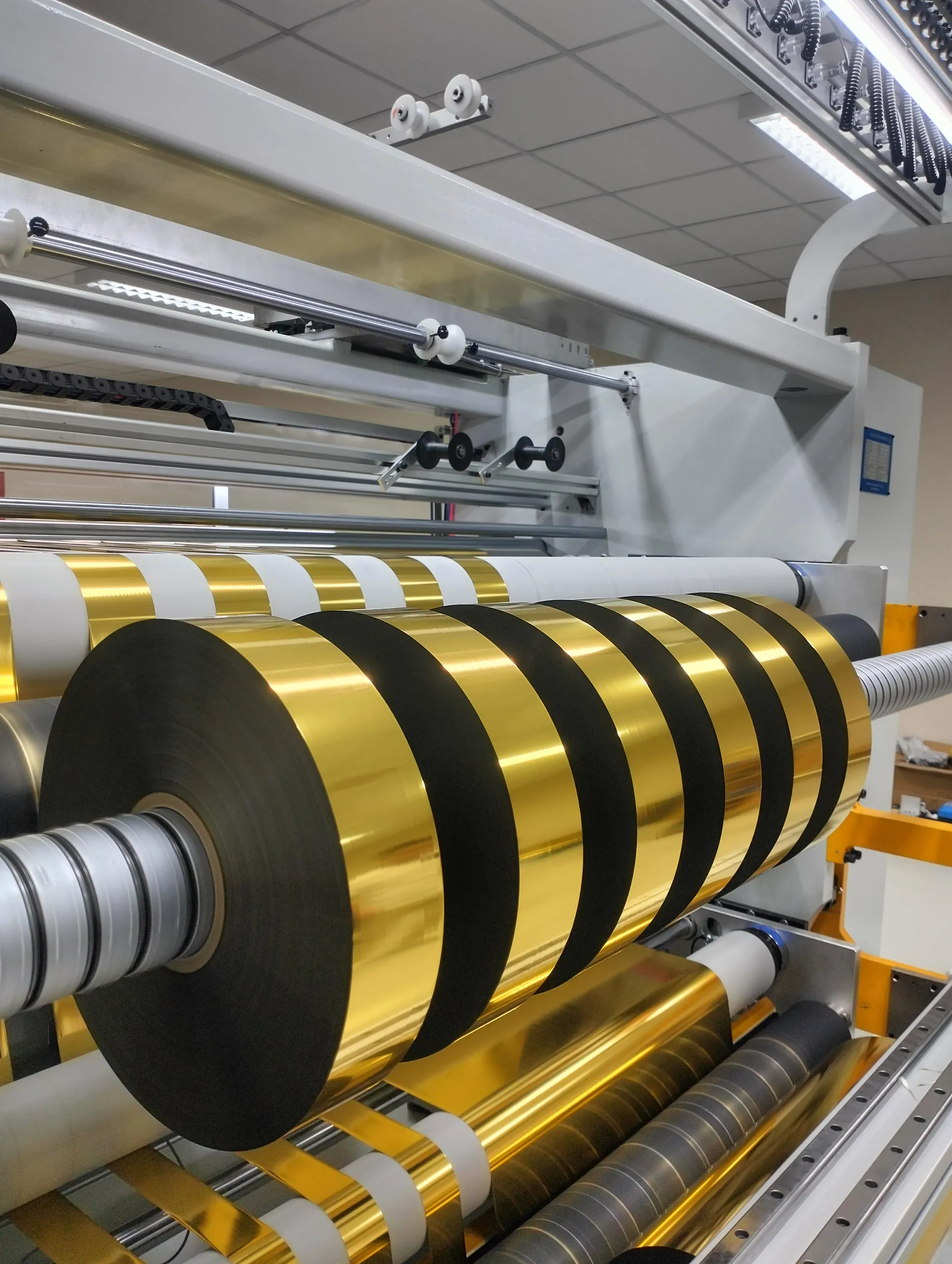 Gold foil rolls on a slitting machine